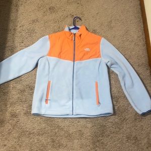 size large north face jacket. fleece like material. light blue and orange colors